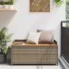 A storage bench on a balcony with plants and pillows. Anteprima dell’immagine prodotto