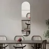 A mirror is mounted on a wall above a dining table with chairs. Produktbild-Vorschau