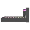 Side view of a gray upholstered bed frame with a slatted mattress base and LED lighting. Voir les images du produit
