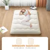 A woman sleeping on a floor mattress in a room. Náhľad obrázku produktu