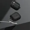 Two black cases for wireless earbuds are shown floating in front of a dark gray background, with a silver wireless charging pad and cable in the foreground. Voir les images du produit