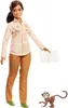 A Barbie doll dressed as a nature photographer, holding a map, with a small monkey figure next to her. Produktbild-Vorschau