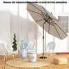 An outdoor patio scene with a beige umbrella, chairs, a stool, and a rug. Produktbild-Vorschau