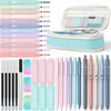 A collection of stationery items including pens, markers, erasers, and a pencil case, arranged on a white background. Produktbild-Vorschau