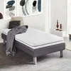 A single mattress on a bed frame in a room with abstract art on the wall. Anteprima dell’immagine prodotto