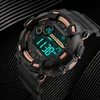 A digital watch with a black strap and gold accents is displayed against a dark, textured background. Podgląd zdjęcia produktu