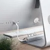 The back of a silver computer with a white keyboard and a silver USB-C hub connected to it. Náhled obrázku produktu