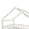 Close-up view of the top part of a white wooden house-shaped bed frame with string lights. Produktbild-Vorschau