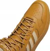A close-up view of the toe and laces of a brown Adidas sneaker. Anteprima dell’immagine prodotto