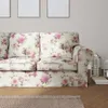 A close-up of a floral patterned sofa in a living room setting. Podgląd zdjęcia produktu