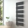 A modern bathroom with a wall-mounted toilet and a sleek, anthracite-colored towel radiator. Podgląd zdjęcia produktu