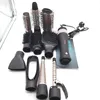 A collection of hair styling attachments and a hairdryer are laid out on a white surface. Anteprima dell’immagine prodotto