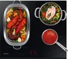 An induction cooktop with food being cooked in pots and a roasting pan. Náhľad obrázku produktu