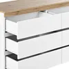 A close-up view of a white dresser with a wooden top, showing several open drawers. Voir les images du produit
