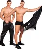 Two men posing in underwear and shiny black pants, one holding a black jacket. Anteprima dell’immagine prodotto