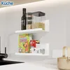 A kitchen scene with two white shelves mounted on a wall, displaying various food items and containers. Voir les images du produit