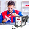 A man is working on a circuit board with a soldering station. Produktbild-Vorschau