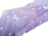 A close-up view of a folded blanket with a unicorn and star pattern. Náhled obrázku produktu