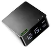 A digital alarm clock with a black casing and a digital display. Anteprima dell’immagine prodotto