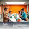 People wrapping gifts around a table in an office setting. Produktbild-Vorschau
