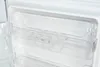 Close-up view of the inside of a refrigerator, showing clear plastic shelving and compartments. Produktbild-Vorschau