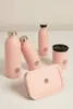 A collection of pink reusable water bottles and a lunchbox arranged on a white surface. Produktbild-Vorschau