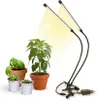 A product shot of a dual-headed LED plant grow light with three potted plants. Náhľad obrázku produktu