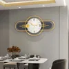 A modern dining room with a table set for a meal, featuring a decorative wall clock. Produktbild-Vorschau