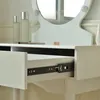 A close-up of a white vanity table with an open drawer, showing drawer slides. Náhled obrázku produktu