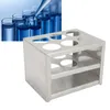 A stainless steel test tube rack with test tubes in the background. Náhľad obrázku produktu