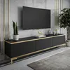 A modern living room setup featuring a black and gold TV stand with a television mounted above it. Produktbild-Vorschau