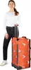 A woman stands next to a rolling suitcase. Produktbild-Vorschau