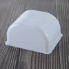 A white plastic container with a rounded lid sits on a dark wooden surface. Produktbild-Vorschau