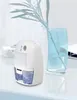 A small white dehumidifier with a blue water tank sits on a white surface next to a blue glass vase with a plant. Náhled obrázku produktu