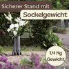A vase with flowers placed in a cemetery setting. Produktbild-Vorschau