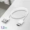 A white USB-C to USB-A charging and data cable coiled on a white surface. Náhľad obrázku produktu
