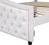 A close-up view of the side and headboard of a white upholstered bed frame. Náhled obrázku produktu
