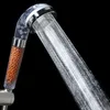 A close-up shot of a shower head with water spraying out, against a black background. Anteprima dell’immagine prodotto
