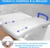 A white bath seat with a blue handle is placed across a bathtub. Náhled obrázku produktu
