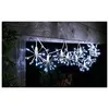 A string of white LED lights shaped like starbursts hangs from a wooden beam outdoors at night. Produktbild-Vorschau