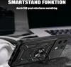 A black phone case with a ring stand is shown in a close-up shot, with a blurred background of a laptop and headphones. Produktbild-Vorschau