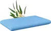 A blue pillow with a sprig of eucalyptus leaves resting on it, set against a white background. Produktbild-Vorschau
