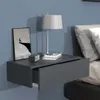 A wall-mounted nightstand with a drawer, a lamp, and a framed picture on top, next to a bed. Podgląd zdjęcia produktu