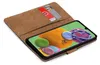 A brown book-style phone case with two credit cards inserted, showing a smartphone screen with a colorful abstract wallpaper. Podgląd zdjęcia produktu