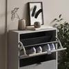 A close-up view of a gray shoe cabinet with its front flap open, revealing two shelves with shoes. Decorative items are placed on top of the cabinet. Anteprima dell’immagine prodotto