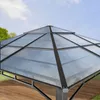 Close-up view of the transparent roof of a gazebo, with a blue sky and green trees in the background. Náhled obrázku produktu