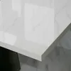 A close-up view of a white, high-gloss tabletop with marble-like veining. Produktbild-Vorschau
