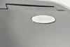 A close-up view of a silver-colored product with a logo. Produktbild-Vorschau