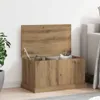 A wooden storage chest with its lid open, placed next to a sofa and a plant. Náhled obrázku produktu