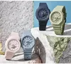 Four Casio G-Shock watches in different pastel colors are displayed on textured rocks against a light blue background. Produktbild-Vorschau